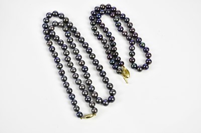 Lot 415 - Two stained black pearl necklaces, each with...