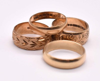 Lot 1206 - Four 9ct yellow gold wedding bands, two with...