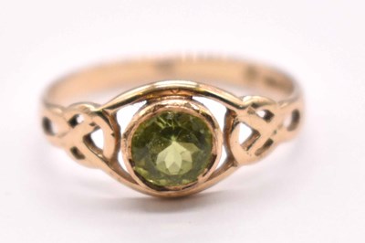 Lot 1208 - A 9ct yellow gold green peridot dress ring,...