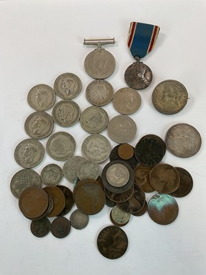 Lot 1329 - A small group of coins, including a George V...