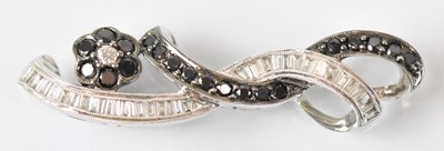 Lot 1439 - A 15ct white gold black and white diamond set...