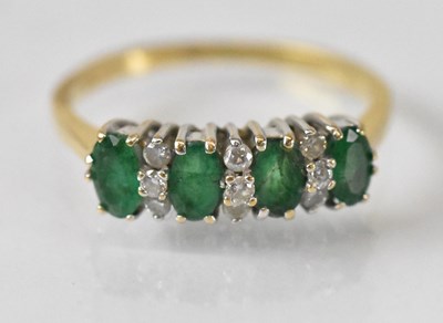 Lot 1438 - An 18ct yellow gold emerald and diamond ring...