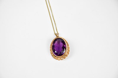 Lot 343 - A large amethyst pendant with seed pearl frame...