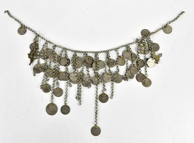 Lot 552 - An unusual white metal adornment set with...