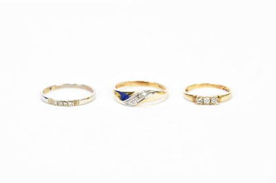 Lot 173 - A 9ct yellow gold three stone diamond ring and...
