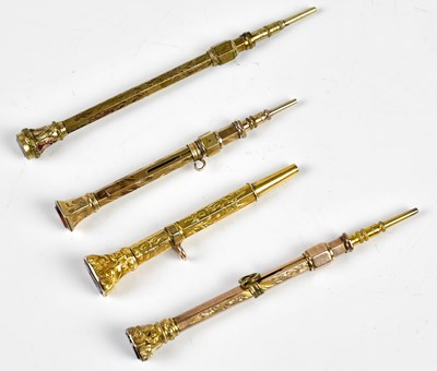Lot 1341 - Four Victorian yellow metal propelling pencils,...