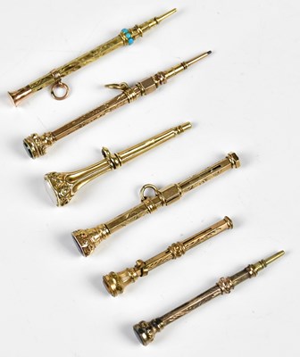 Lot 1330 - Six Victorian yellow metal propelling pencils,...