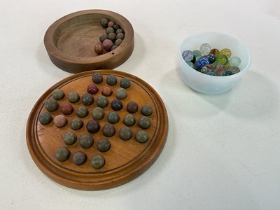 Lot 387 - A vintage wooden solitaire game with clay...