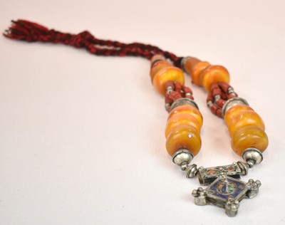 Lot 1221 - A Sudanese amber white metal and cloth...