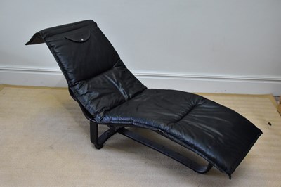 Lot 2054 - A contemporary ebonised wooden framed chaise...
