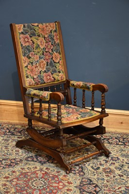 Lot 1082 - A late Victorian American style rocking chair...