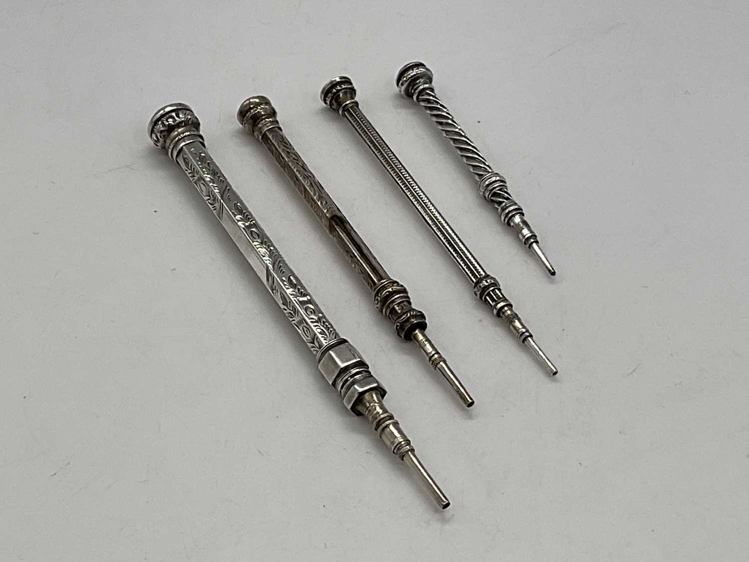 Lot 46 - Four silver propelling pencils.