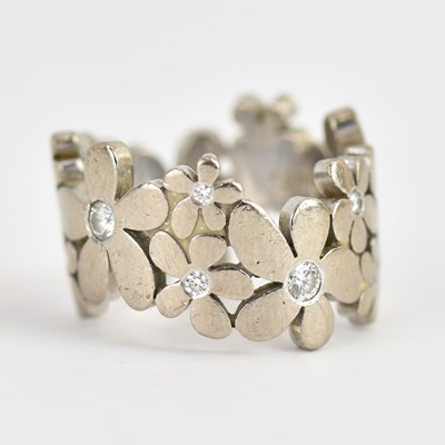 Lot 948 - An 18ct white gold contemporary ring in the...