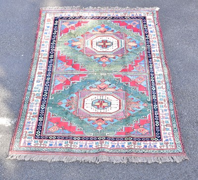 Lot 1470 - A Caucasian green ground hand woven wool rug,...