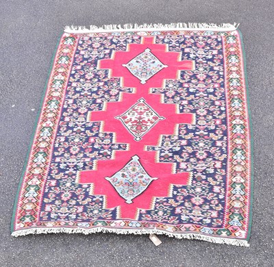 Lot 1484 - A Caucasian red ground hand knotted wool rug...