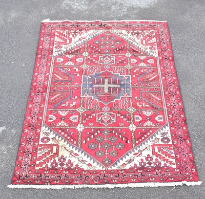 Lot 1487 - A Caucasian hand woven wool rug, decorated...