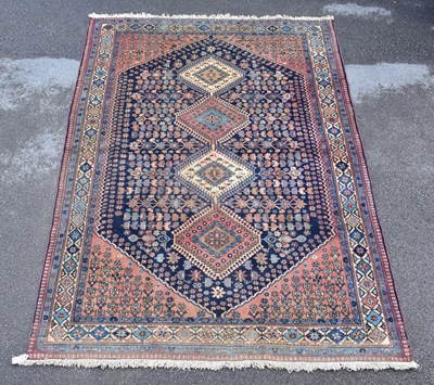 Lot 1477 - A Caucasian hand woven wool rug, with floral...