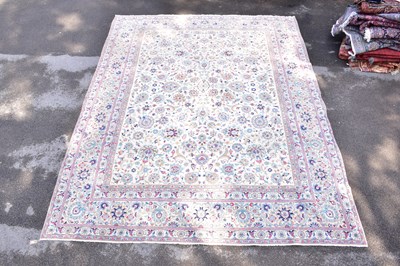 Lot 1461 - A Persian hand woven wool rug, with flower...