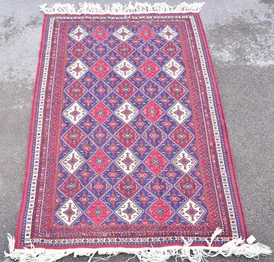 Lot 1479 - A Caucasian hand woven wool rug, with central...