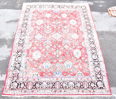 Lot 1463 - A Persian hand woven wool rug, with large over...
