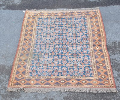 Lot 1480 - A Caucasian hand woven wool rug, with central...