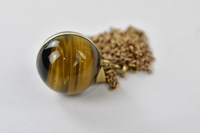 Lot 2466 - A yellow metal mounted tiger's eye pendant...