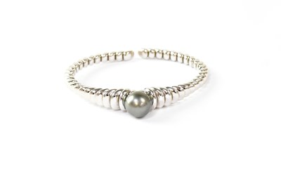 Lot 987 - MAUBOUSSIN; an 18ct white gold beaded bangle,...