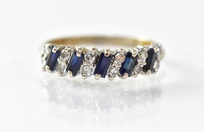 Lot 985 - A white metal ring set with baguette cut...