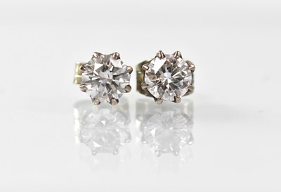 Lot 1013 - A pair of white metal diamond stud earrings,...