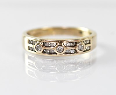 Lot 970 - A 9ct gold ring with three collet set diamonds,...