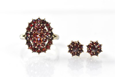 Lot 1020 - A 900 grade silver ring set with garnets and a...