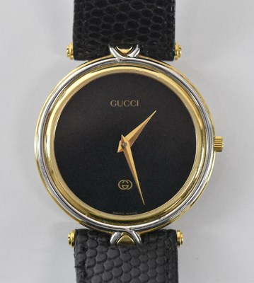 Lot 1652 - GUCCI; a gentleman's wristwatch with black...
