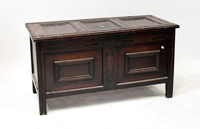 Lot 52 - A Georgian oak coffer with panelled lid above...