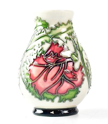 Lot 124 - MOORCROFT; a small vase decorated with pink...