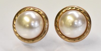 Lot 1555 - A pair of yellow metal and pearl set earrings,...