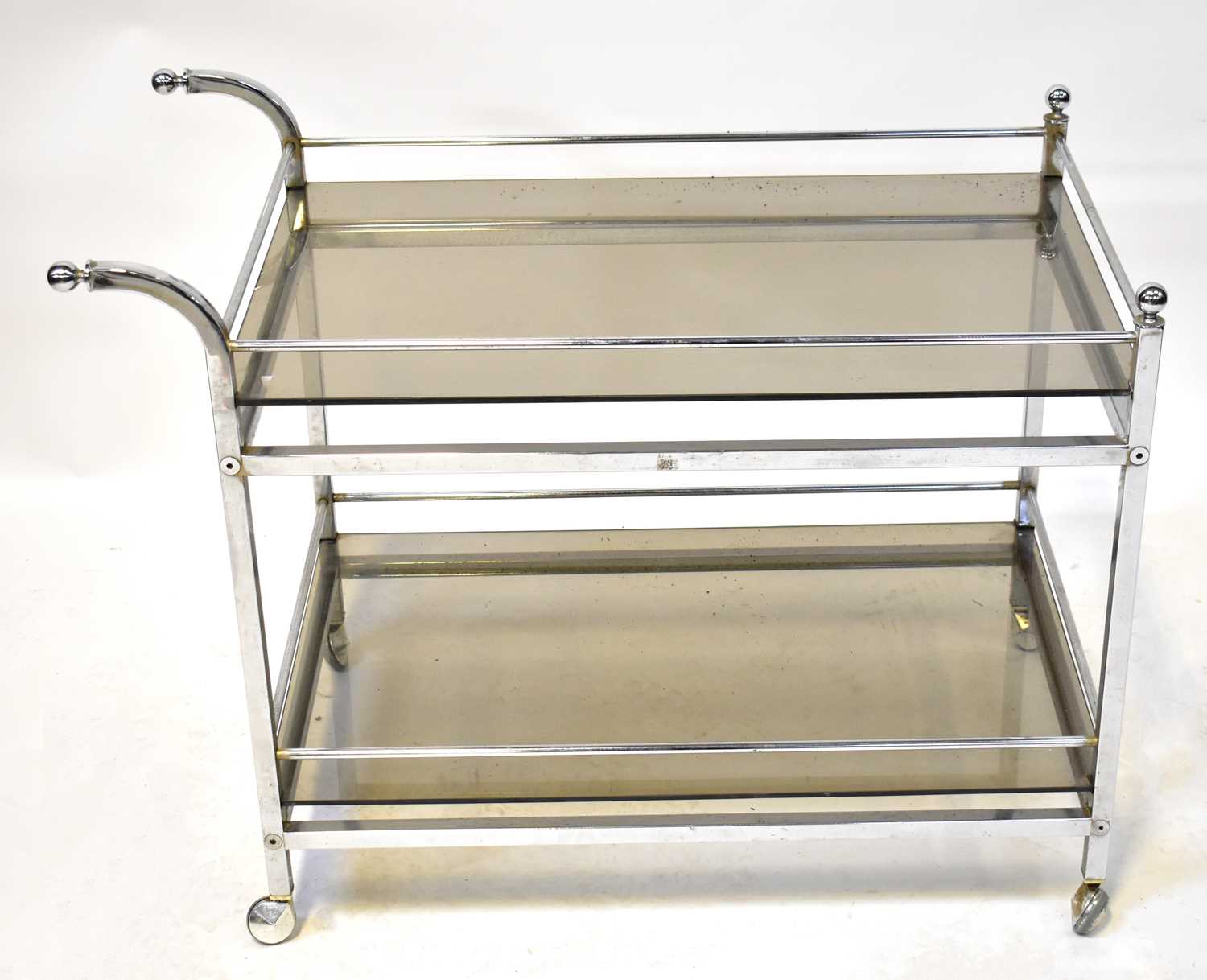 Lot 10 - A smoked glass and chrome two-tier drinks...