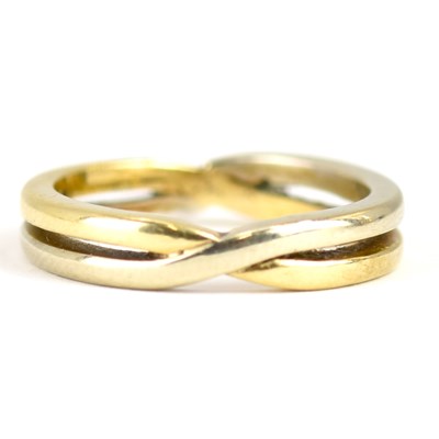 Lot 969 - A 9ct gold two-colour crossover band ring,...