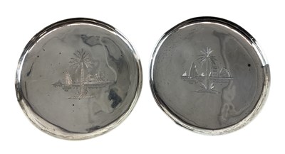 Lot 1342 - A pair of white metal pin dishes decorated...