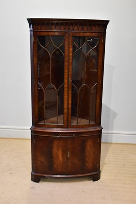 Lot 257 - A reproduction mahogany bowfronted corner...