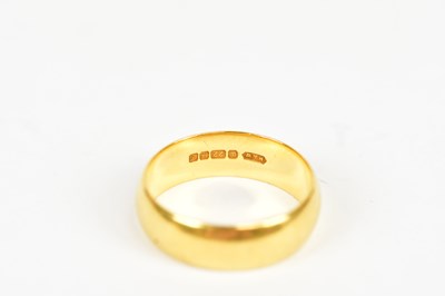 Lot 2395 - A 22ct yellow gold wedding band, size K,...