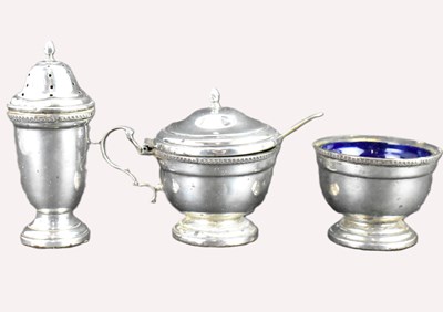 Lot 917 - A three-piece hallmarked silver cruet...
