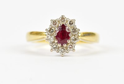 Lot 2413 - An 18ct gold diamond and ruby oval ring,...