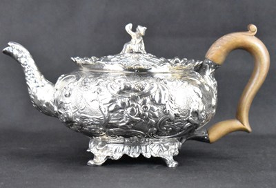 Lot 906 - A George III hallmarked silver teapot with all-...