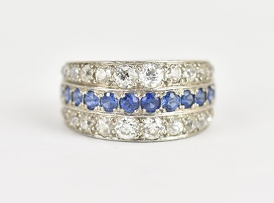 Lot 984 - A white metal ring set with continuous row of...