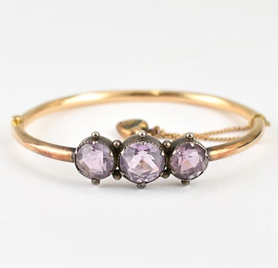 Lot 990 - An Edwardian gold hinged bracelet with three...