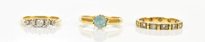 Lot 2410 - An 18ct dress ring set with a blue coloured...