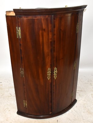 Lot 2912 - A Georgian mahogany bowfront hanging corner...