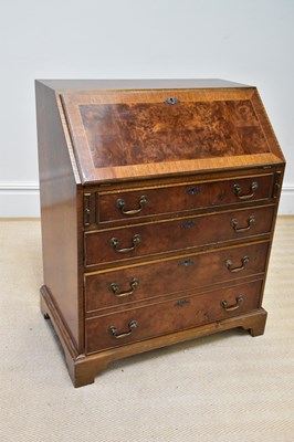 Lot 255 - A reproduction walnut bureau, the fall front...