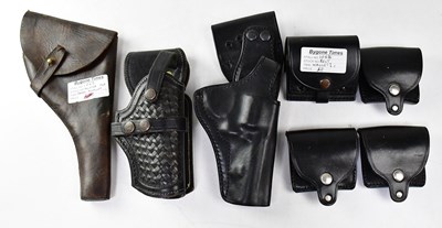 Lot 482 - Three leather pistol holsters, one stamped to...