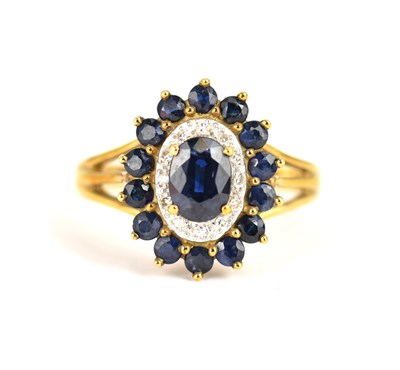 Lot 975 - A 9ct gold cluster ring claw set with central...
